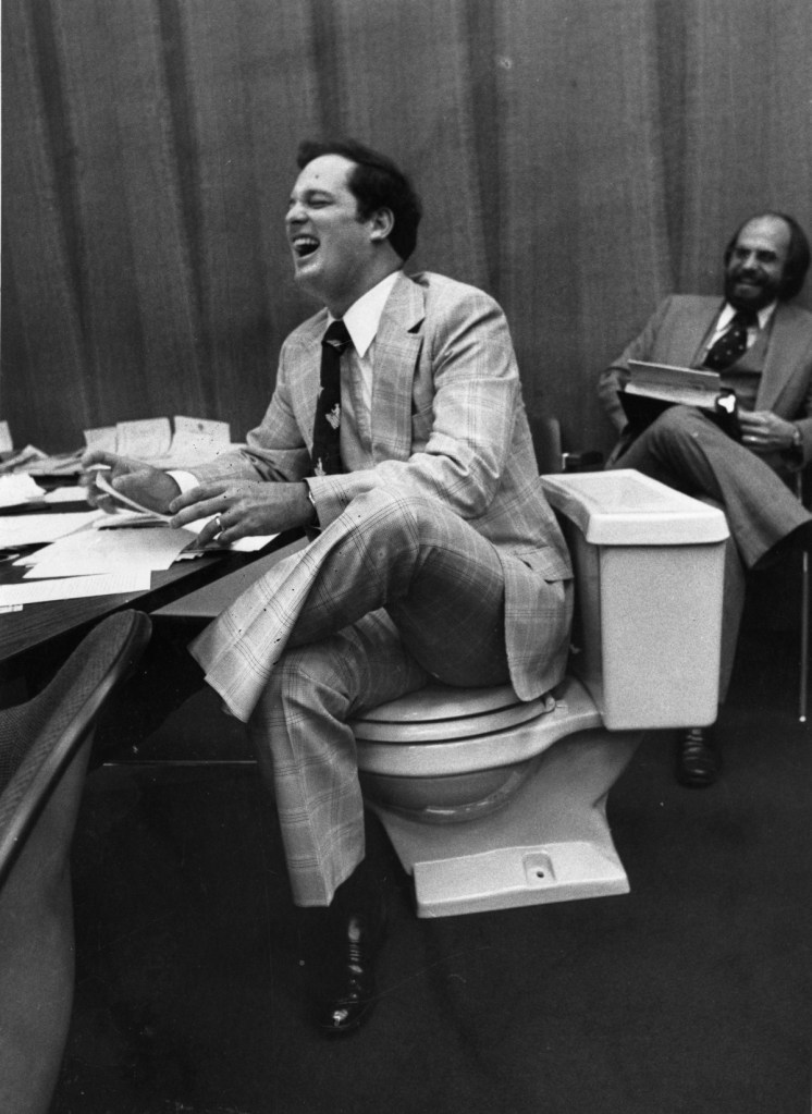 Senator Robert McKnight sits on a toilet seat in the Florida Senate. (Image courtesy of the Donn Dughi Collection, State Archives of Florida)