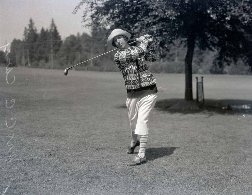 Image shows Mrs. C. C. Cary posing with a golf club (image courtesy of the Oregon Journal Negative Collection)