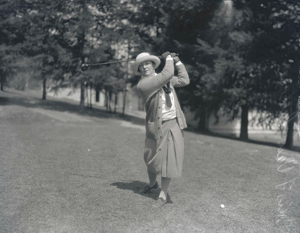 Image shows Mrs. V. Van Patten posing with a golf club (image courtesy of the Oregon Journal Negative Collection)