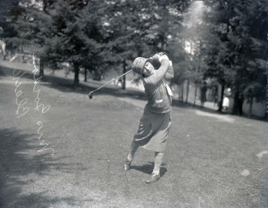 Image shows Mrs. Gordon Black posing with a golf club (image courtesy of the Oregon Journal Negative Collection)