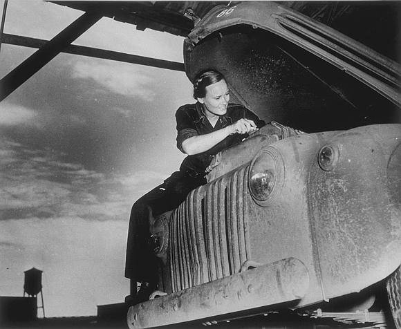 Image shows a woman working on a truck engine (image courtesy of the U.S. Army Signal Corps Photograph Collection, Library of Virginia)