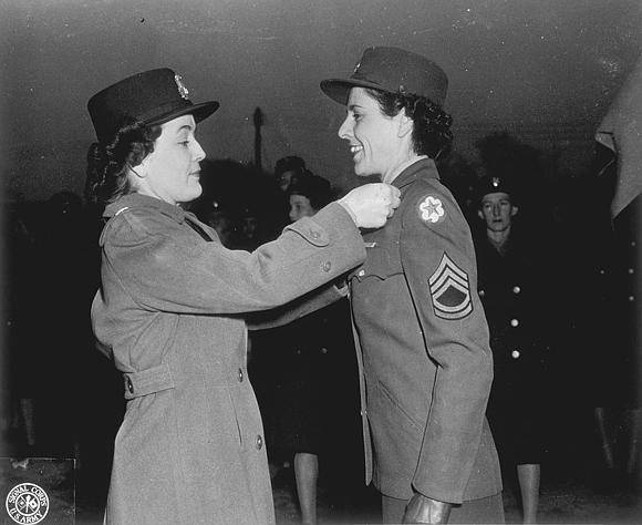 Image shows a woman pinning an award onto another woman's uniform (image courtesy of the U.S. Army Signal Corps Photograph Collection, Library of Virginia)