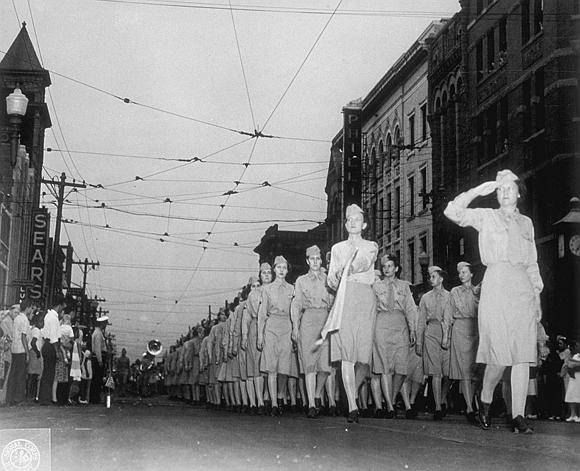 Image shows a group of women marching through a city (image courtesy of the U.S. Army Signal Corps Photograph Collection, Library of Virginia)