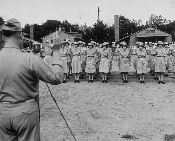 Image shows a group of women taking the oath of enlistment in uniform (image courtesy of the U.S. Army Signal Corps Photograph Collection, Library of Virginia)